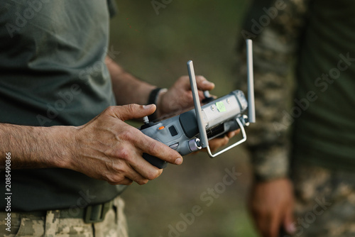 Ukrainian military personnel operating reconnaissance drone controller learning to fly uav