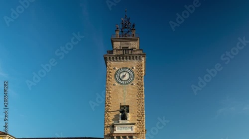 Bergamo Piazza Vittorio Veneto Torre dei Caduti tower with moving shadows and time lapse of morning sunlight illuminating historical architecture in Italy