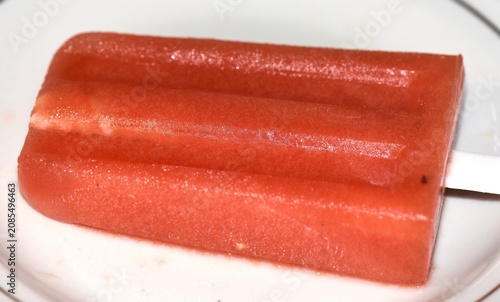 Watermelon ice cream on a plate wooden background 