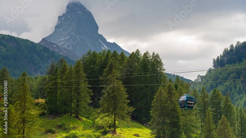 Zermatt Switzerland mountain landscape timelapse with rushing clouds over the iconic Matterhorn peak and alpine pine forest scenery