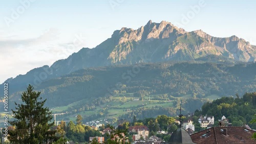 Sunset time lapse of Mount Pilatus with moving shadows over the historic skyline of Lucerne, Switzerland, highlighting alpine peaks