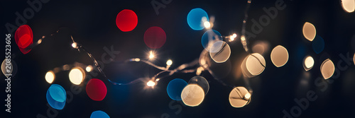 Close-up of glowing string lights with bokeh effect in dark setting