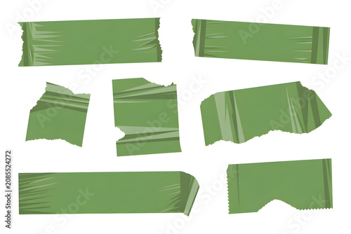 Close-up of Torn Green Paper Strips on White Background