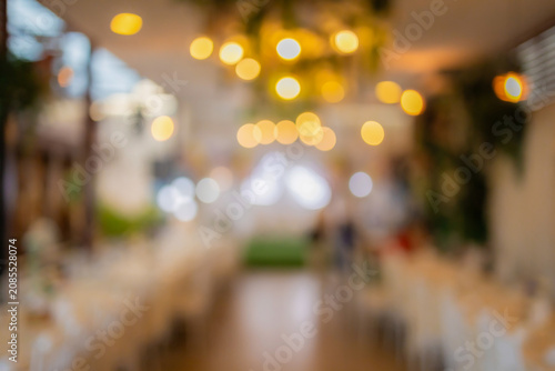Vintage tone blur image of food stall at night festival with bokeh for background usage. Festival Event Party with People Blurred Background. Blur people having sunset beach party in summer vacation