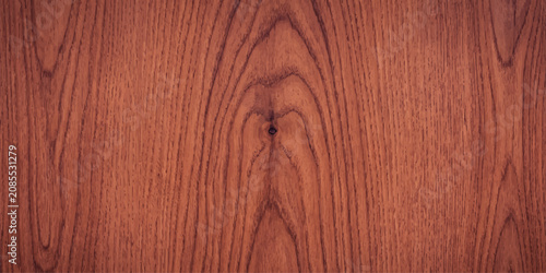 Photos Close-up of rich, reddish-brown wood grain pattern with a prominent central knot and natural lines, offering a warm and rustic texture