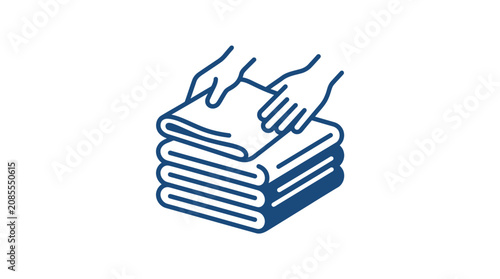 Hands folding a stack of clean towels.