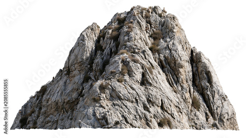Jagged grey granite mountain peak with sparse dry vegetation