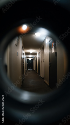 Empty Apartment Hallway Seen Through Door Peephole at Night
