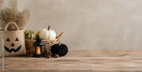 Rustic Autumn Halloween Decor with Jack-o'-Lantern Bag, Pumpkins, and Lantern on Wooden Table
