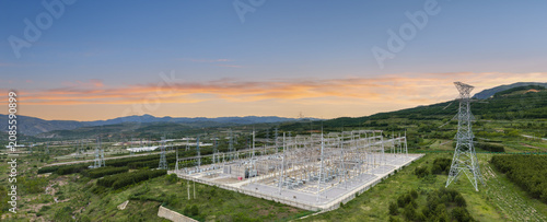 Ultra-Large Substation at Dawn with Integrated Energy Storage and Mountainous Landscape