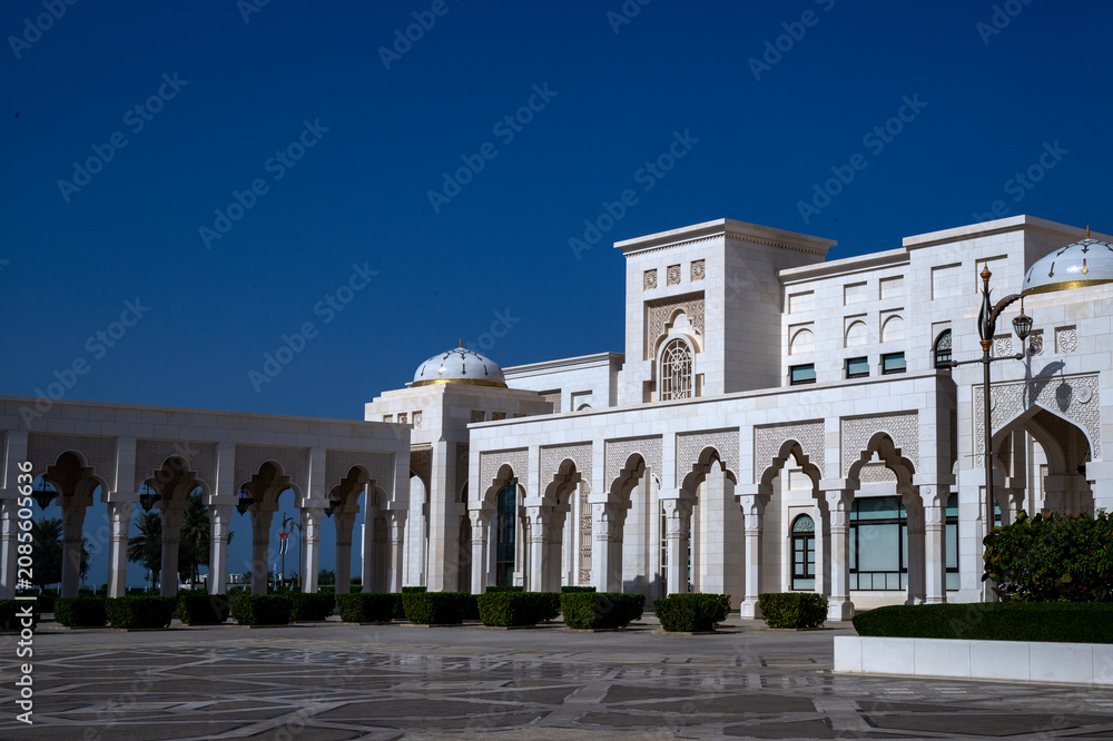 Fototapeta premium Horizontal medium shot of the intricate white marble facade and columned porticos of Qasr Al Watan presidential palace, Abu Dhabi.