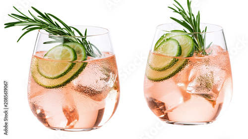 Tableau sur toile Two pink gin cocktails with lime slices and rosemary sprigs