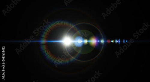 A bright, white light source emits a rainbow-colored lens flare across a dark background.