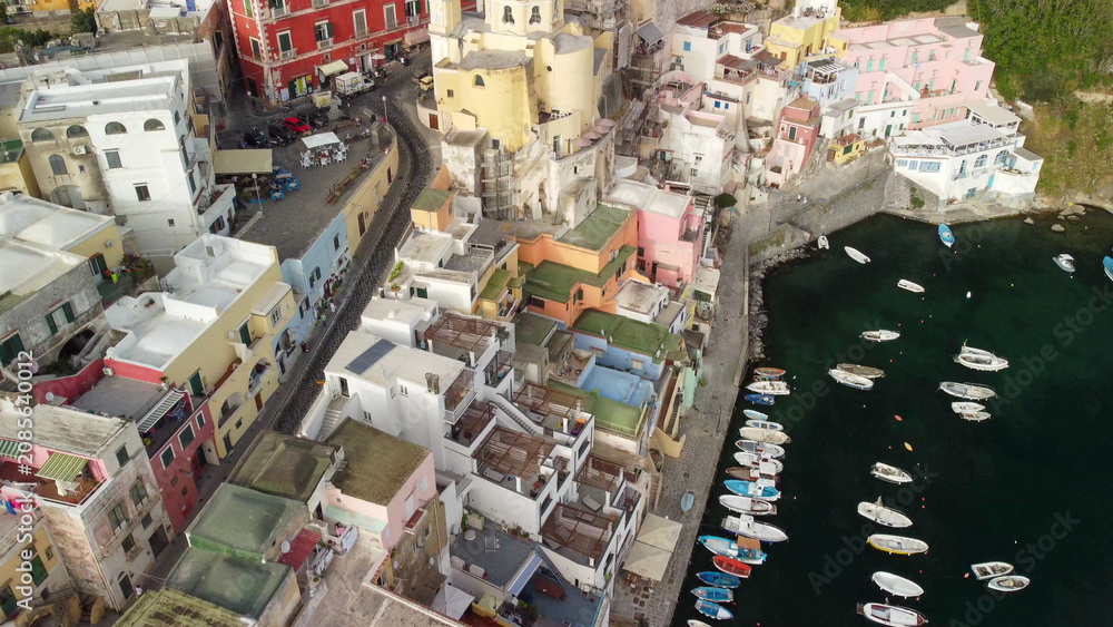 Fototapeta premium Stunning sunset view of Procida island old town and Mediterranean coast.