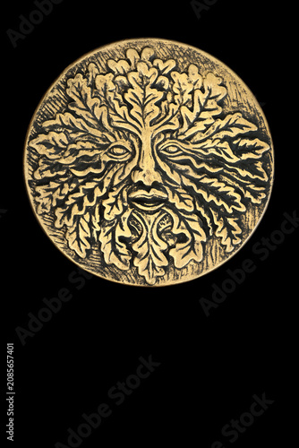 Green Man symbol gold plaque nature tree spirit decoration on black background. Nature figure symbol of rebirth in medieval folklore, cycle of life concept. Not copyrighted. 
