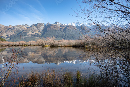 Clear mountain reflection on the water at Glenorchy Lagoon Scenic Walkway in autumn, Otago, New Zealand