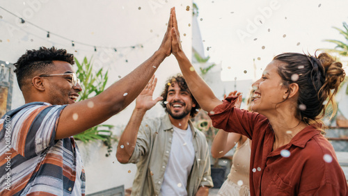 Friends Giving High Five With Festive Confetti