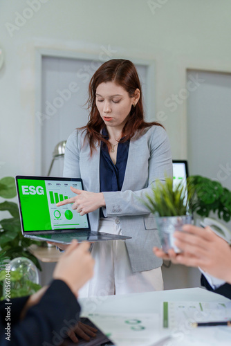 Businesswoman presenting ESG data during corporate meeting