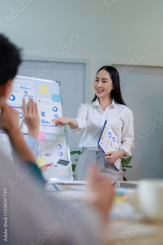 Businesswoman presenting data analysis during an office meeting