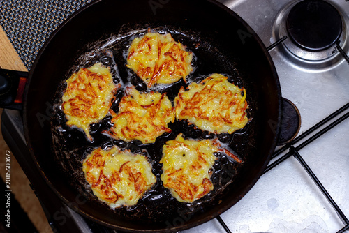 potato pancakes are fried in a frying pan