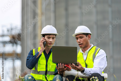 Engineers communicating and planning work on construction site