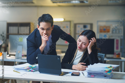 Business colleagues feeling exhausted working overtime late night