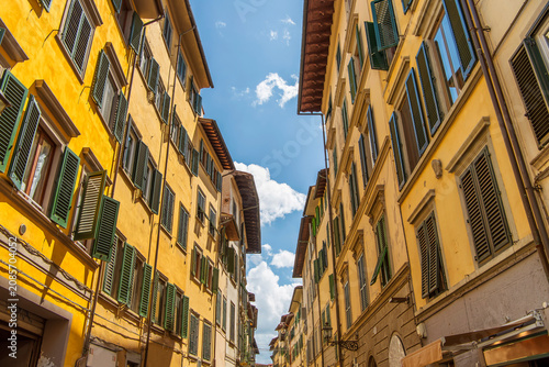 Yellow exterior of apartment buildings in the city of Florence italy