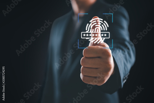 Information security technology concept with business person approving biometric verification. Virtual fingerprint scanner hologram representing safe internet access and private data encryption.