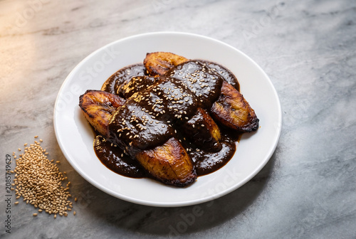 Mole de Plátano - Guatemalan Fried Plantains in Chocolate Mole Sauce – With Copy Space