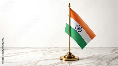 Mini Indian flag on golden stand over marble surface.
