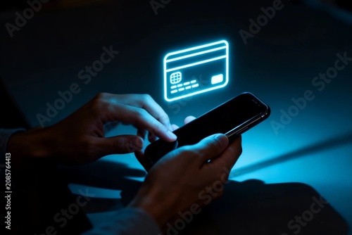 Hands using smartphone with glowing credit card icon