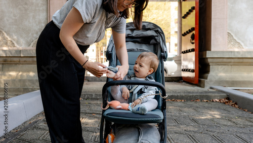 Mother caring for her child outside historical temple