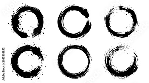 Six hand-drawn black enso circles with brush strokes and ink splatters on white, ideal for grunge design elements, artistic frames, or spiritual concepts.