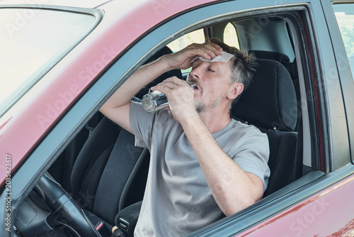 Photos Driver experiencing heatstroke, sweat and dehydration in hot car