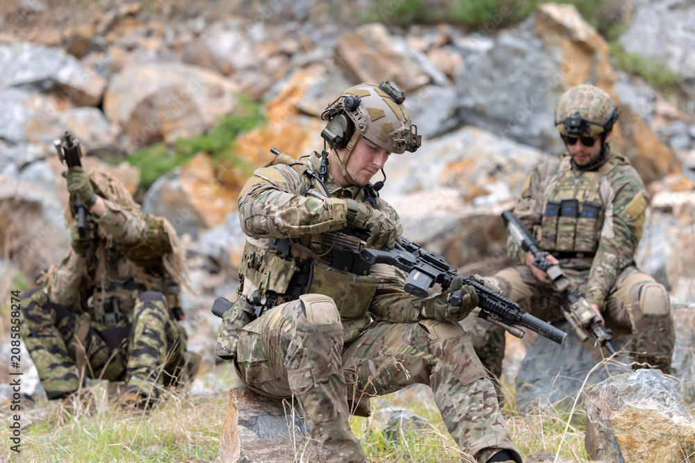 Fototapeta premium Soldier inspecting rifle during the mission