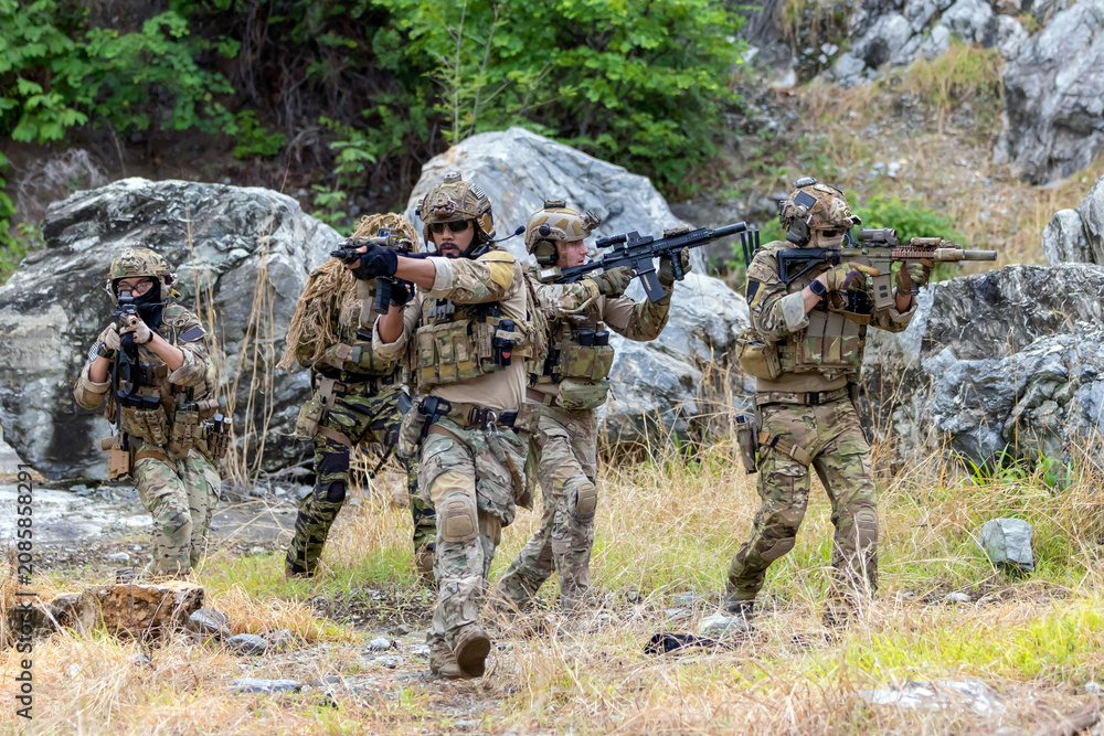 Fototapeta premium Military participate in a patrol in forrest terrain