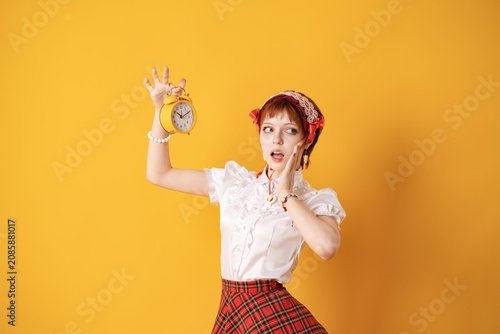 Картината върху платно A young girl in a studio on a yellow background