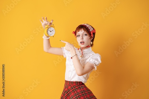 Принти на полотні A young girl in a studio on a yellow background