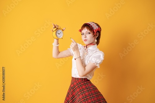 Принти на полотні A young girl in a studio on a yellow background