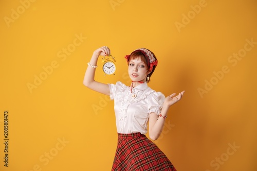 Принти на полотні A young girl in a studio on a yellow background