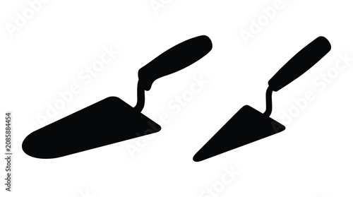 Canvastavla Two trowels in black silhouette against a white background