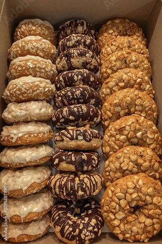 Bakery Display Showing Assorted Donuts and Cookies Arranged in a Box