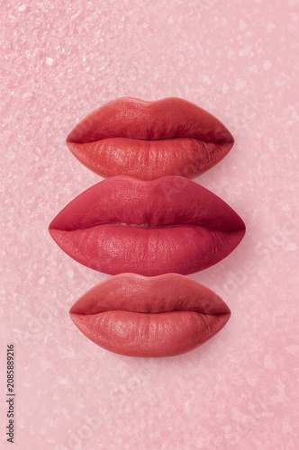 Close up of Lips With Light Pink Lipstick on a Plain Background During Makeup...