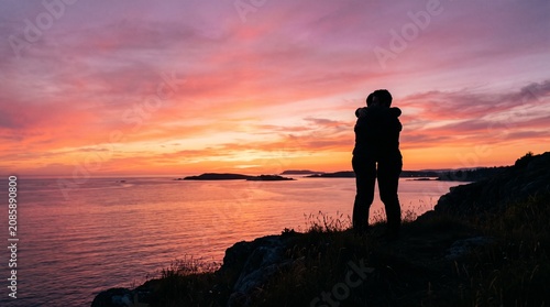 Two Silhouettes Embracing at Sunset Symbolizing Forgiveness and Love