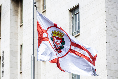 Sao Paulo city flag fluttering in the wind with building in the background. Brazil