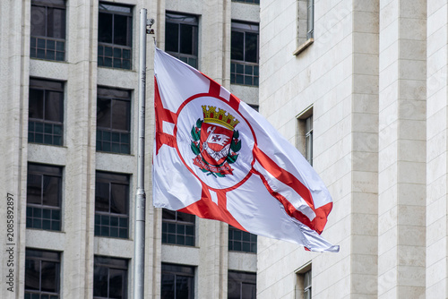 Sao Paulo city flag fluttering in the wind with building in the background. Brazil