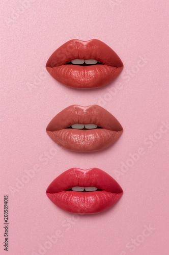 Different Shades of Lip Colors Arranged on a Pink Background for a Beauty Dis...