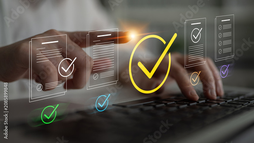Tableau sur toile A close-up view of hands holding a pen ready to approve documents, illustrated with colorful checkmark icons, representing meticulousness in project management and team collaboration