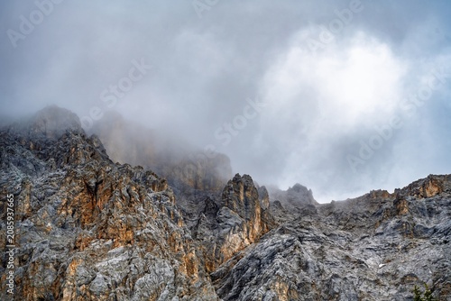 Dramatic rugged limestone peaks of the Wetterstein mountains in the clouds