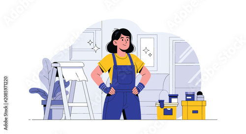 Confident female painter or renovation worker wearing denim overalls standing in front of a ladder in a room.